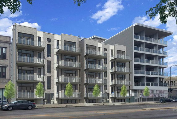 Front view of a modern multi-story apartment building with balconies.