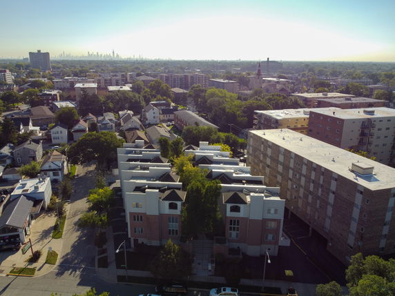Aerial panoramic view of a residential area with apartment buildings and houses.