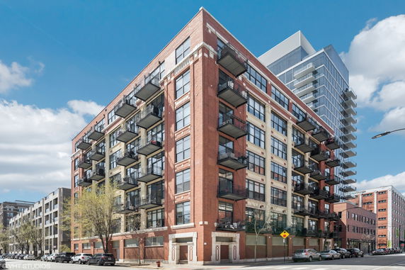 Front view of a multi-story apartment building with balconies.