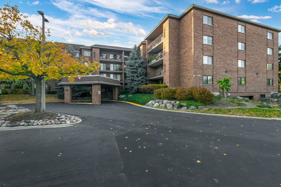 Front view of a multi-story brick building with balconies.