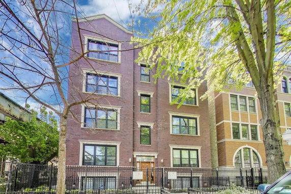 Front view of a multi-story brick apartment building.