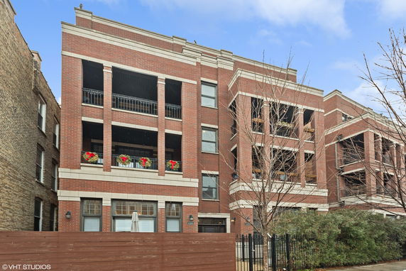 Front view of a multi-story brick apartment building.