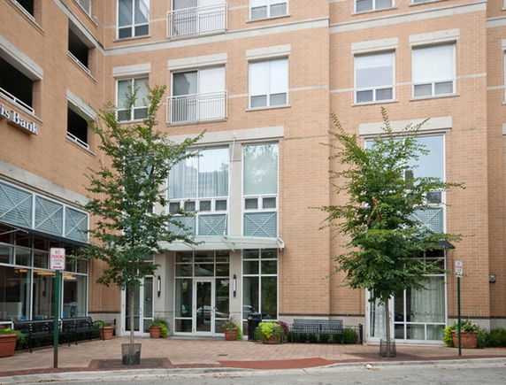 Front view of a multi-story building with large windows and entrance.
