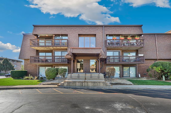 Front view of a multi-story building with balconies.