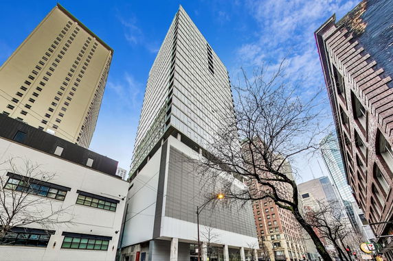 Front view of a modern multi-story building with a glass facade.