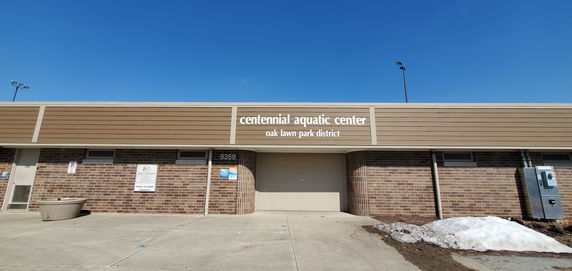 Front view of a building labeled Centennial Aquatic Center.