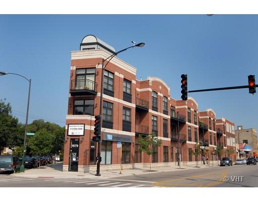 Front view of a multi-story brick commercial building on a street corner.