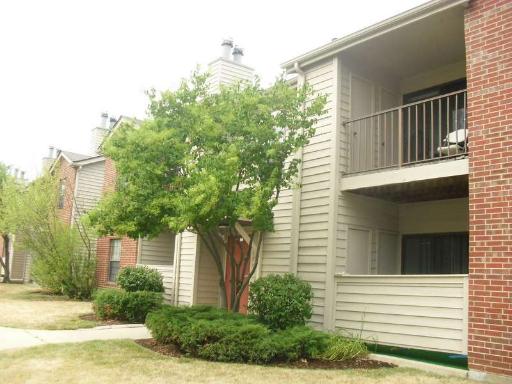 Front view of a multi-story apartment building with balconies.
