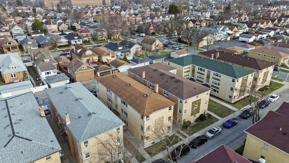 Aerial view of a suburban neighborhood with multiple houses and buildings.