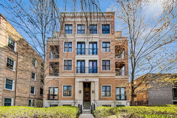 Front view of a multi-story apartment building with brick facade.