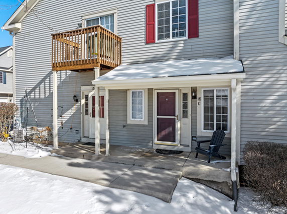 Front view of a house with a balcony and dual entrances.