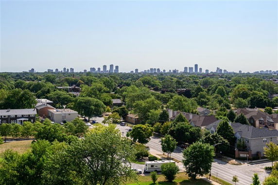 Panoramic view of a residential area with a distant skyline of urban buildings.