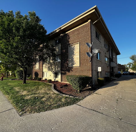 Front view of a three-story brick apartment building.