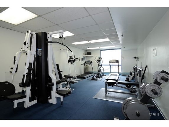 Interior view of a gym with various exercise equipment.