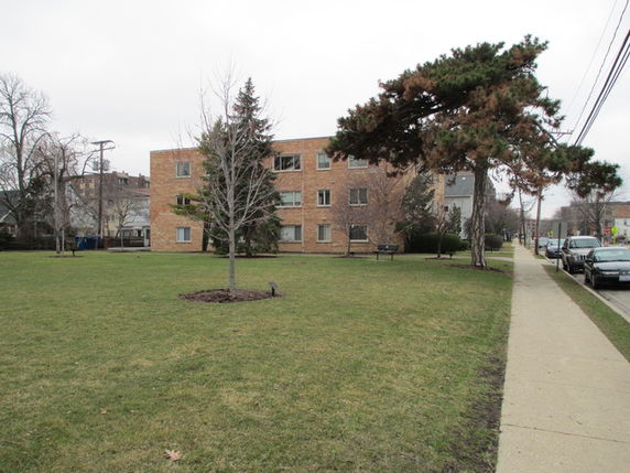 Front view of a three-story brick apartment building.