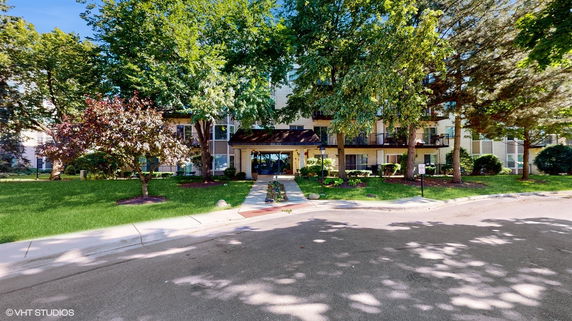 Front view of a multi-story residential building with balconies.