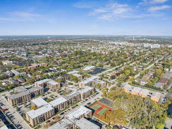 Aerial panoramic view of a residential area with apartment complexes and surrounding neighborhood.