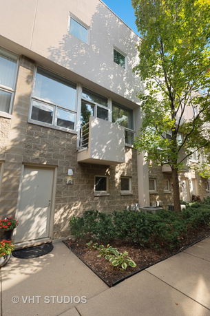 Front view of a multi-story building with brick and stucco exterior.