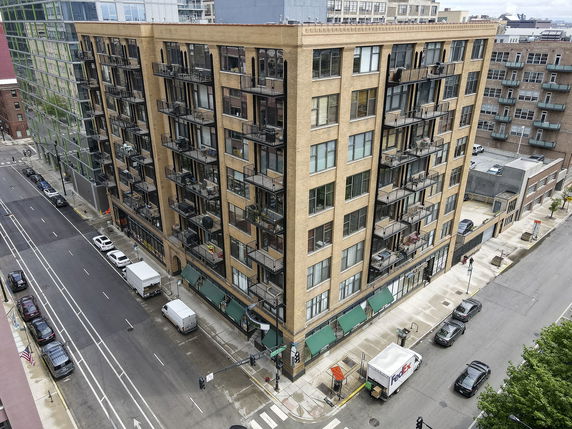 Front view of a multi-story apartment building with balconies.