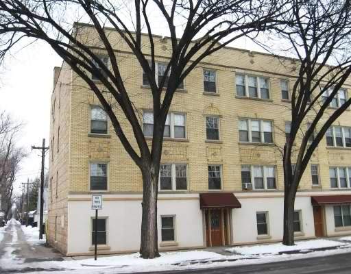 Front view of a multi-story brick apartment building.