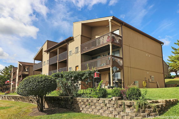 Front view of a multi-story apartment building with balconies.