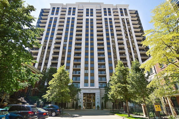 Front view of a multi-story residential building with multiple balconies.
