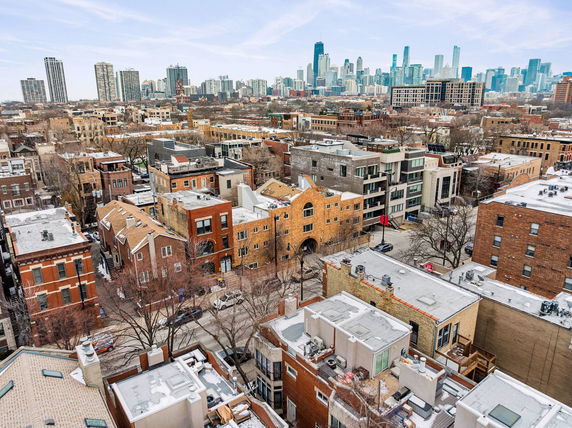 Panoramic view of urban residential area with city skyline in the background.