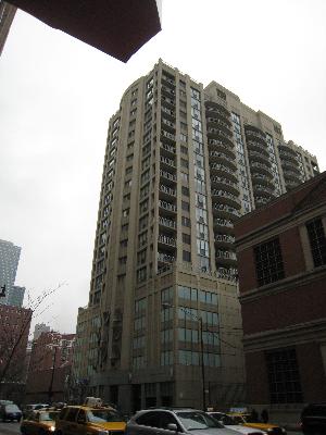 Front view of a high-rise residential building with balconies.