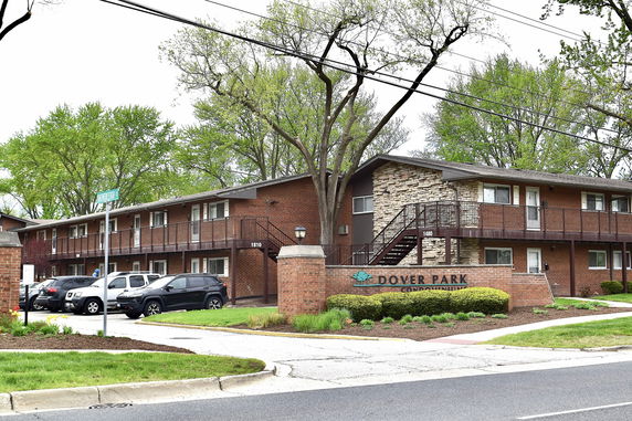 Front view of a two-story condominium building with brick exterior.