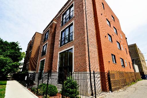 Front view of a multi-story brick apartment building.