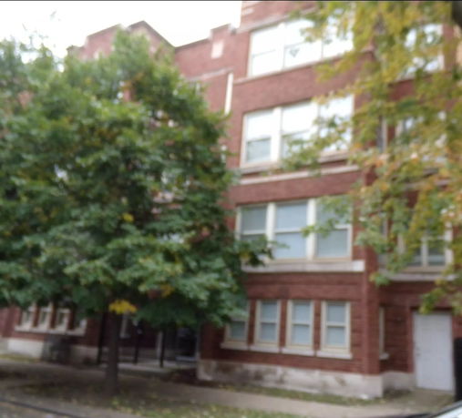 Front view of a multi-story brick building.
