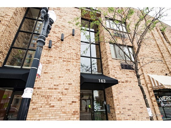 Front view of a multi-story brick building entrance.