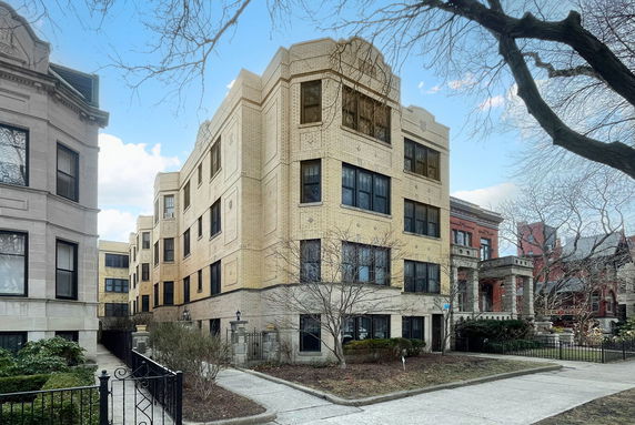 Front view of a multi-story building with brick facade.