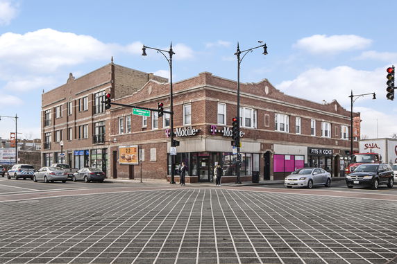 Front view of a two-story commercial building on a street corner.