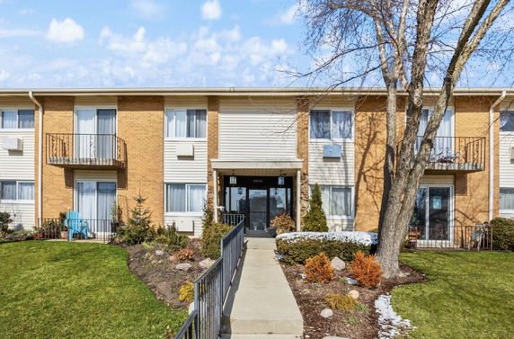 Front view of a two-story apartment building with balconies.