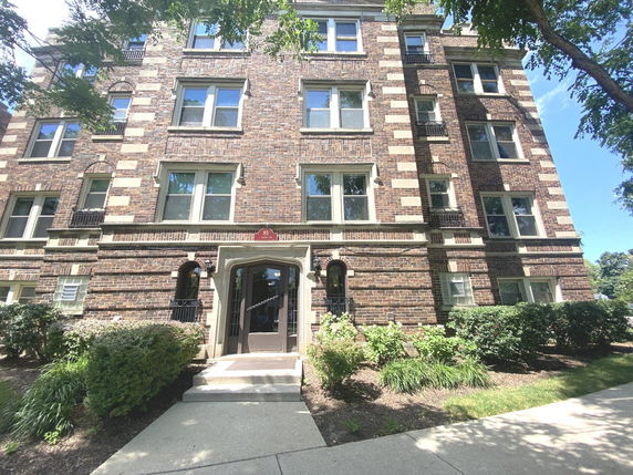 Front view of a multi-story brick apartment building.