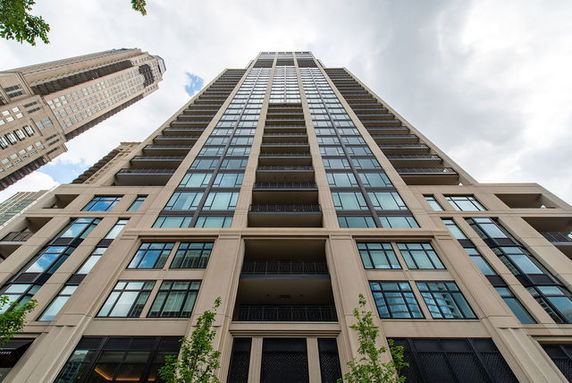 Front view of a high-rise building with multiple balconies.