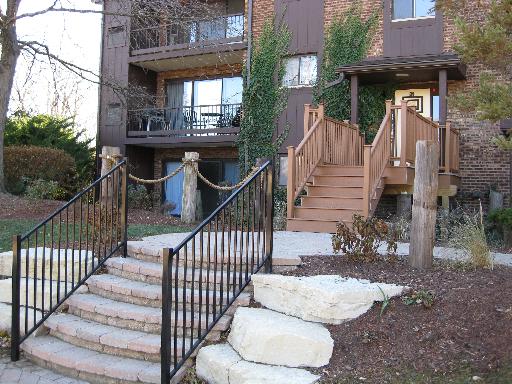 Front view of a building with a staircase and balcony.