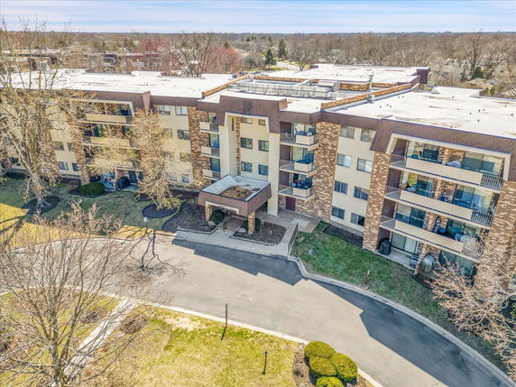 Front view of a multi-story apartment building with balconies.