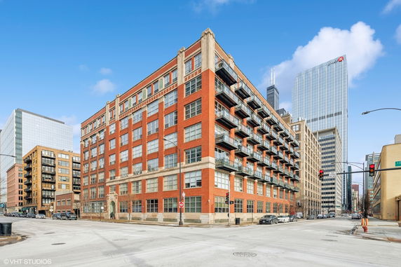 Front view of a multi-story brick building in an urban area.