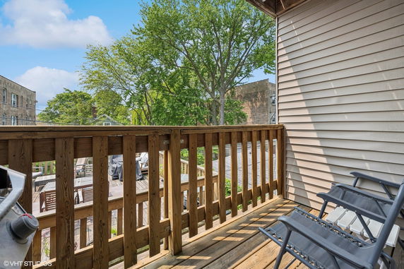 View from a balcony showing chairs and surrounding trees.