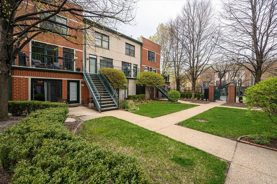 Front view of a multi-story residential building with brick and stone exterior.