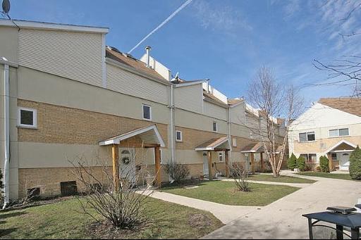 Front view of a multi-level building with individual entrances.