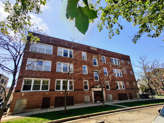 Front view of a three-story brick apartment building.