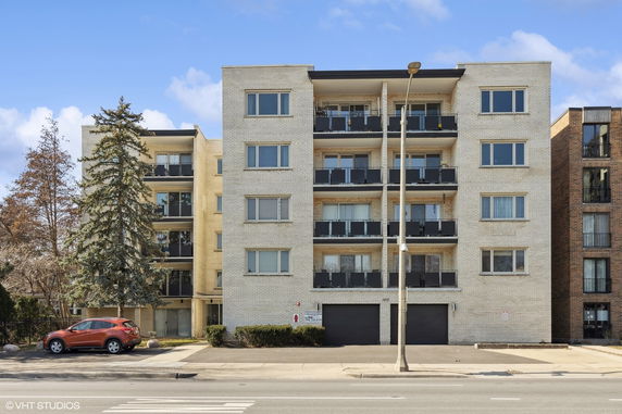Front view of a five-story apartment building with balconies.