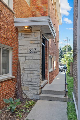 Front view of a brick building with address number 317.