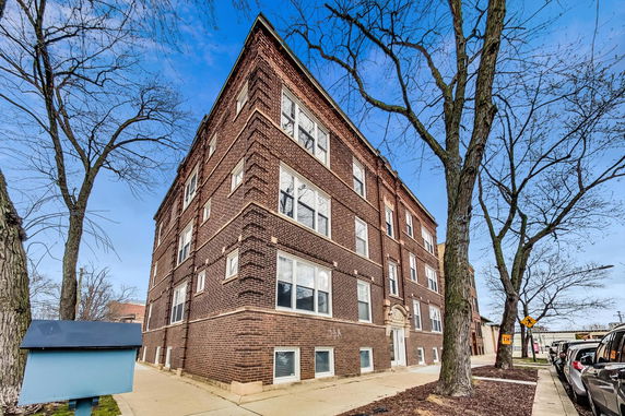 Front view of a multi-story brick apartment building.