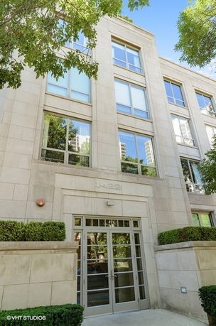 Front view of a modern multi-story building with large windows.