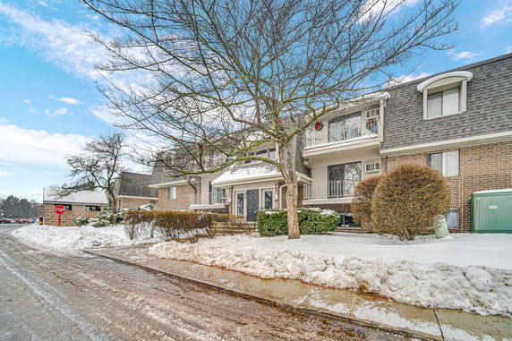 Front view of a multi-story building with snow-covered surroundings.