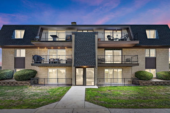 Front view of a multi-story residential building with balconies.